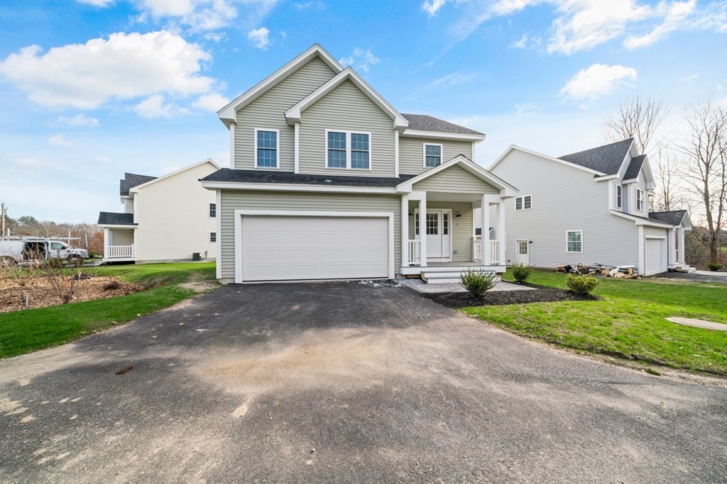 184 Berlin Road Bolton, MA 01740 - Photo 21 of 33 a front view of a house with a yard and garage