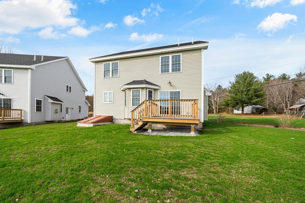 184 Berlin Road Bolton, MA 01740 - Photo 22 of 33 a view of a house with a backyard