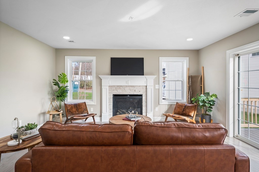 184 Berlin Road Bolton, MA 01740 - Photo 25 of 33 a living room with furniture and a fireplace