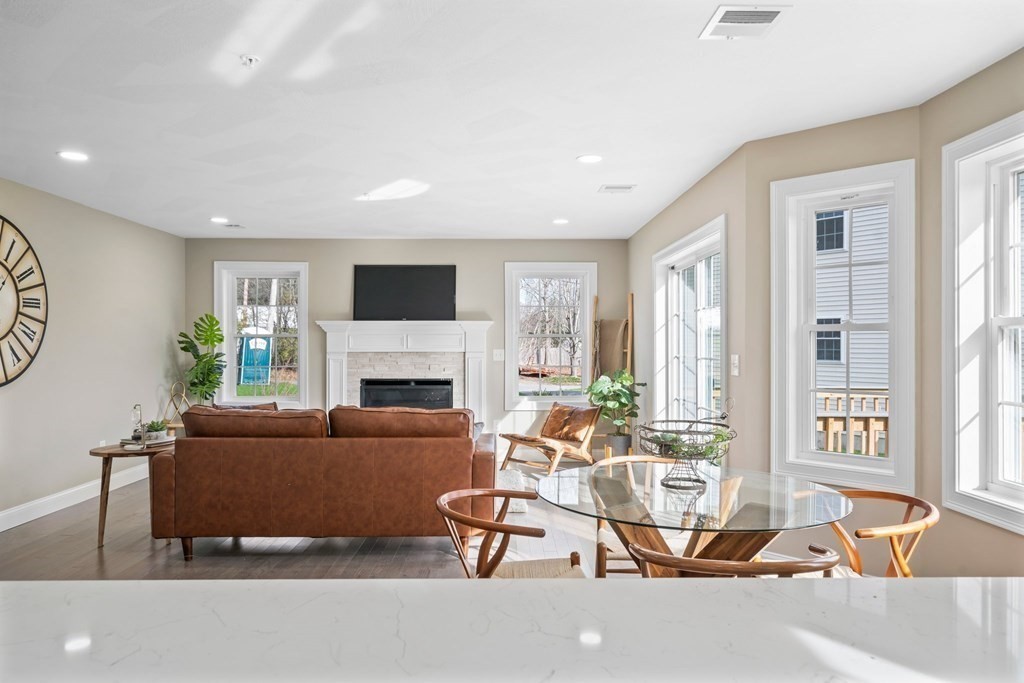 184 Berlin Road Bolton, MA 01740 - Photo 4 of 33 a living room with furniture a fireplace and a flat screen tv