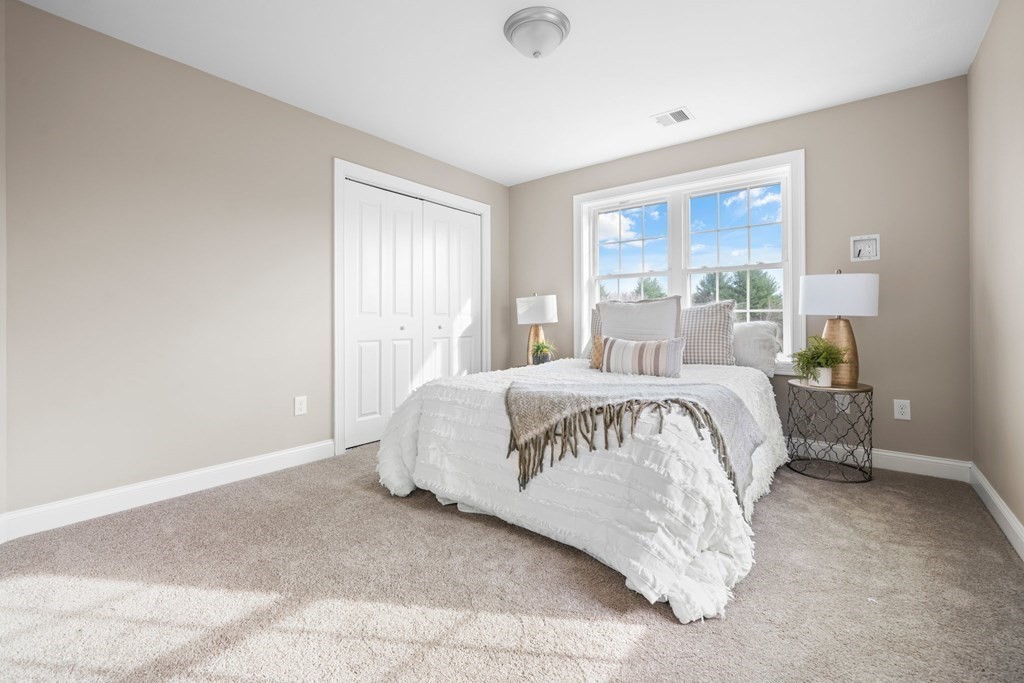 184 Berlin Road Bolton, MA 01740 - Photo 8 of 33 a large bed sitting in a bedroom next to a window