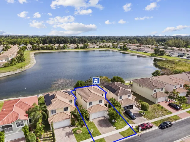 an aerial view of a house with a lake view