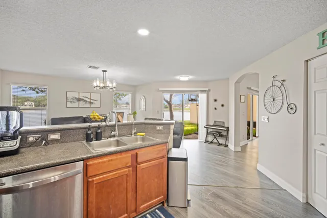 a kitchen with stainless steel appliances granite countertop a sink and cabinets