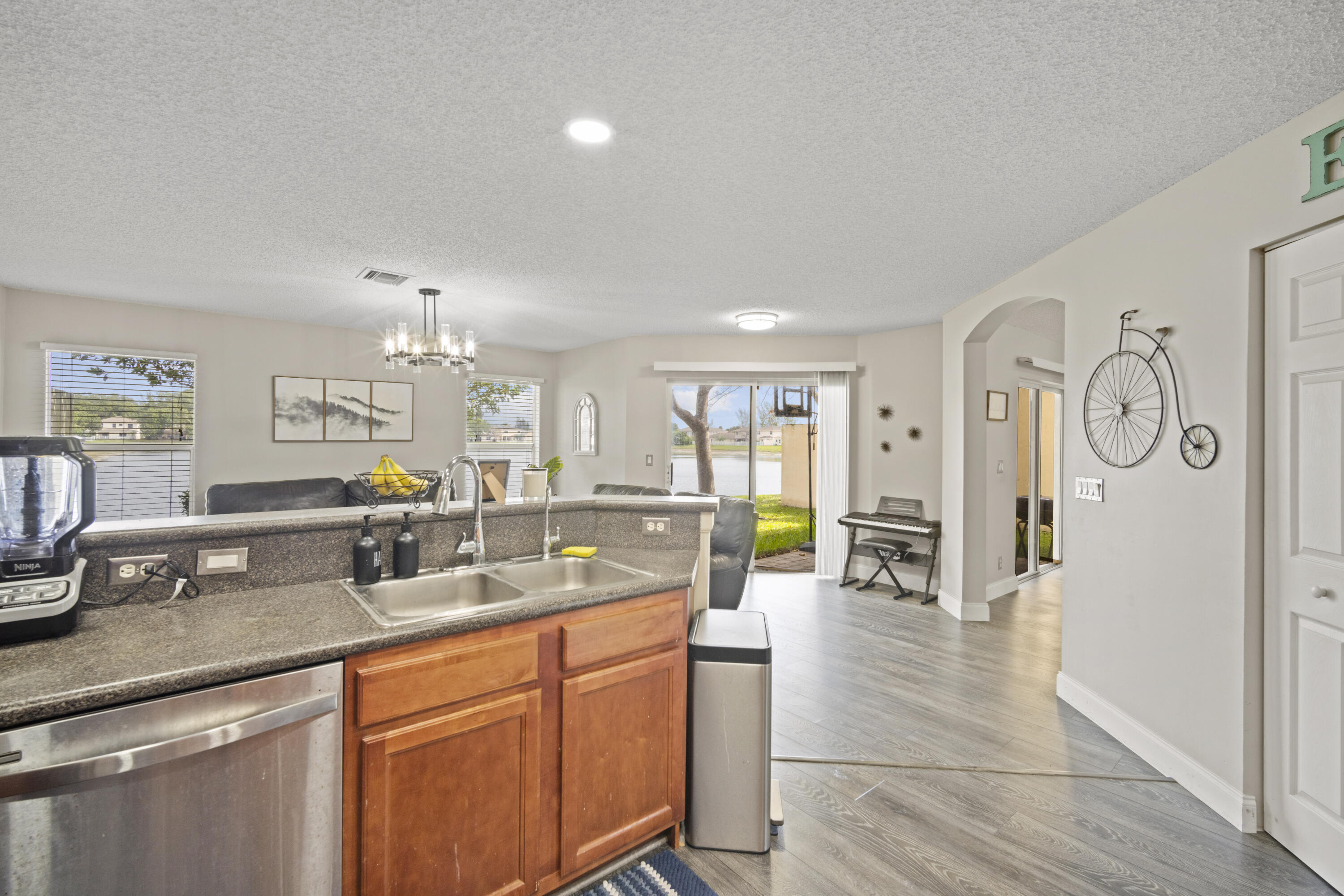 6427 Adriatic Way Greenacres, FL 33413 - Photo 11 of 33 a kitchen with stainless steel appliances granite countertop a sink and cabinets