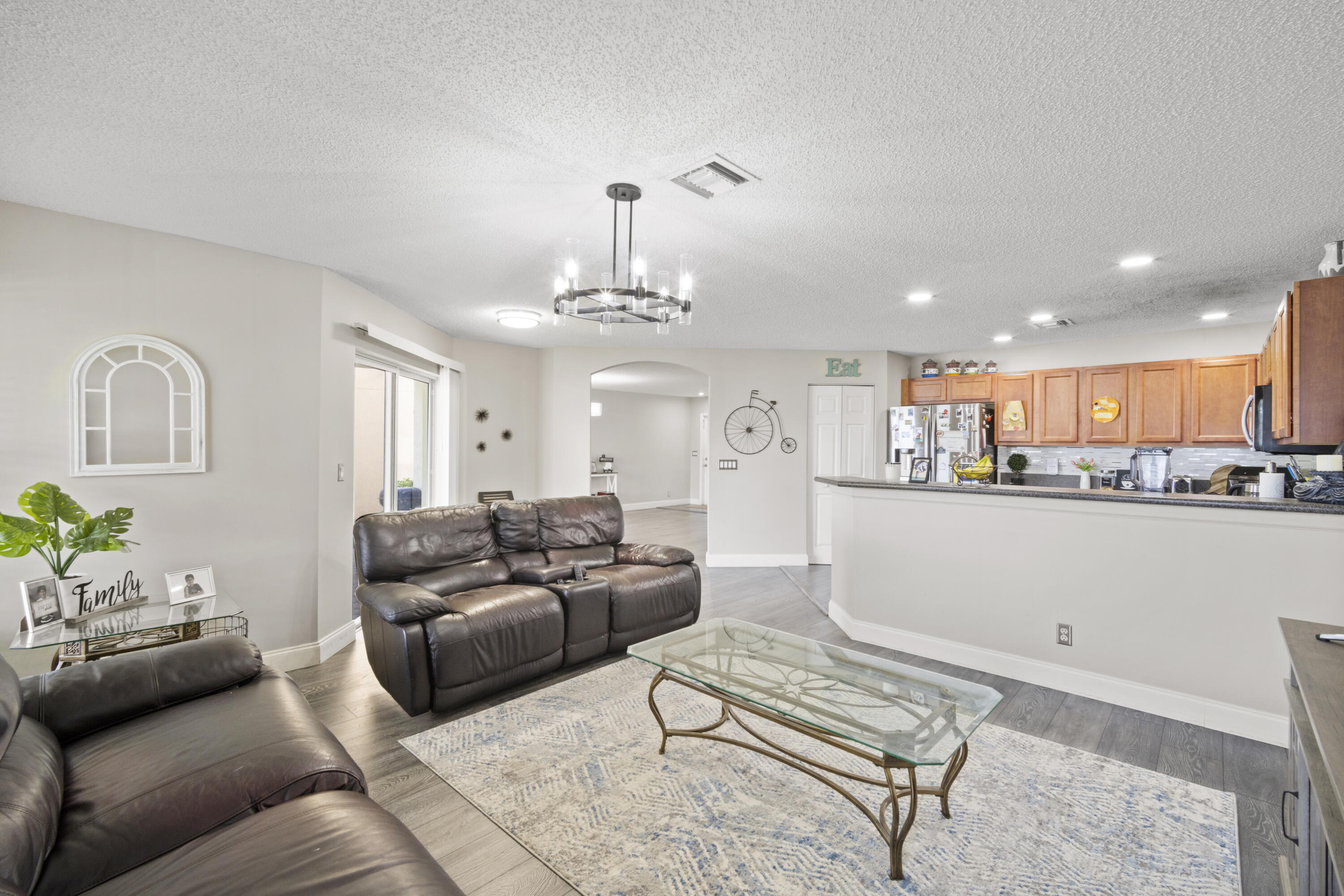 6427 Adriatic Way Greenacres, FL 33413 - Photo 12 of 33 a living room with furniture and a chandelier