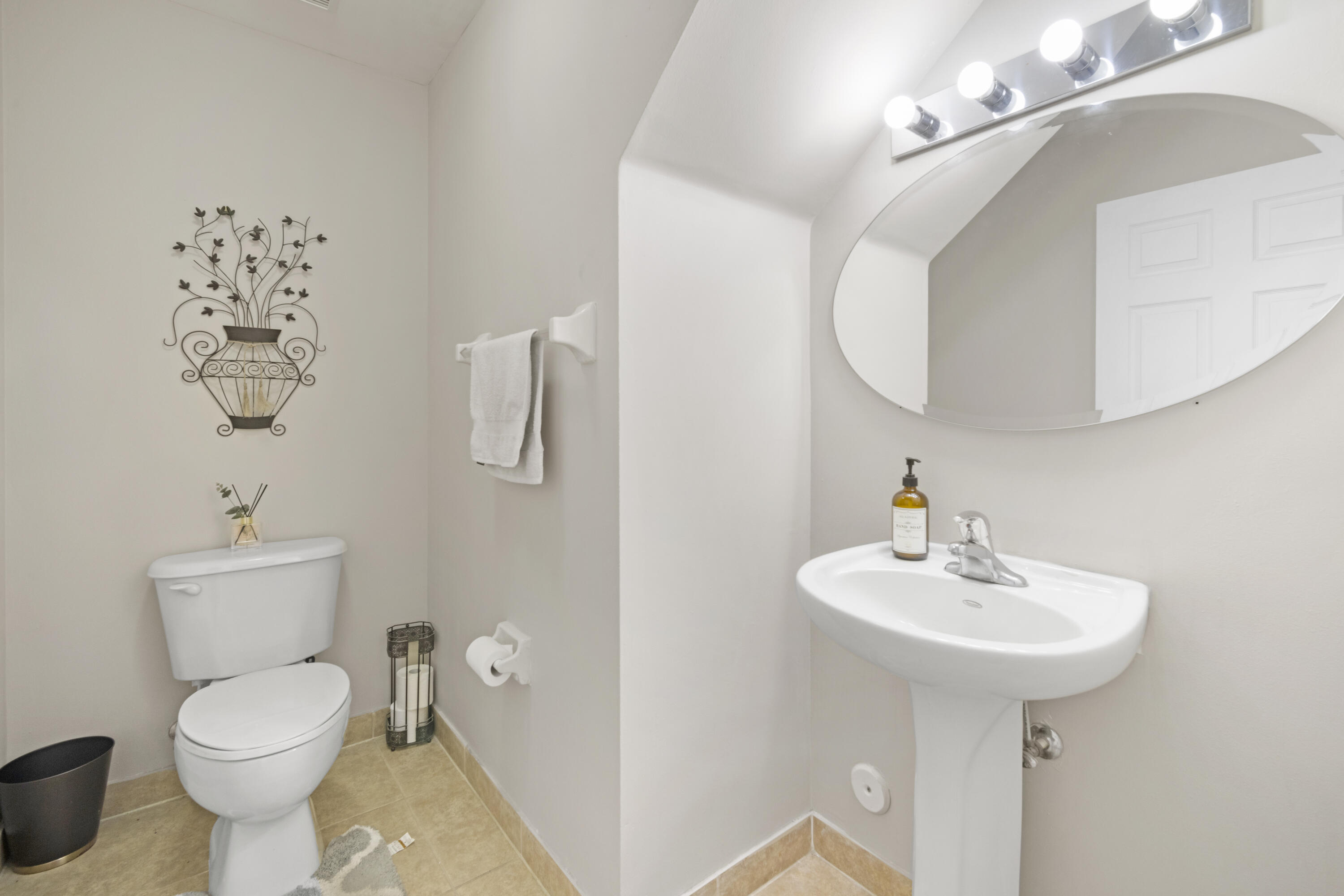 6427 Adriatic Way Greenacres, FL 33413 - Photo 13 of 33 a bathroom with a toilet sink and mirror