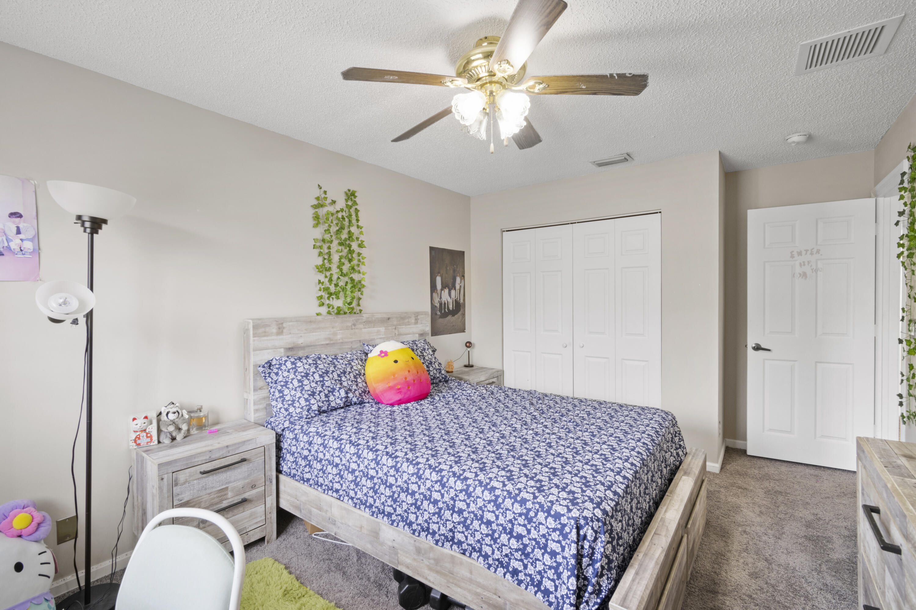 6427 Adriatic Way Greenacres, FL 33413 - Photo 15 of 33 a bedroom with a bed and a chandelier