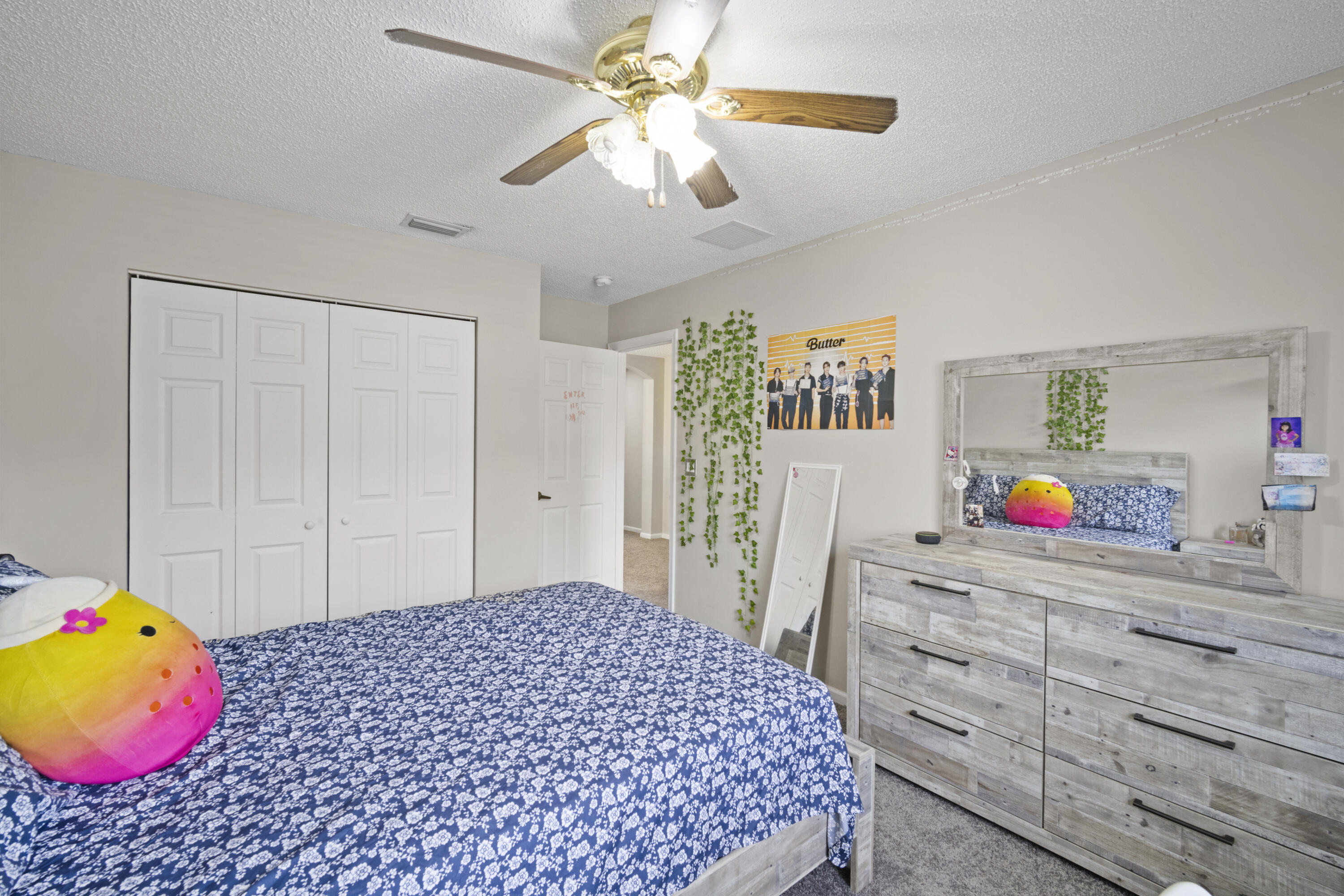 6427 Adriatic Way Greenacres, FL 33413 - Photo 16 of 33 a bedroom with a bed dresser and a chandelier