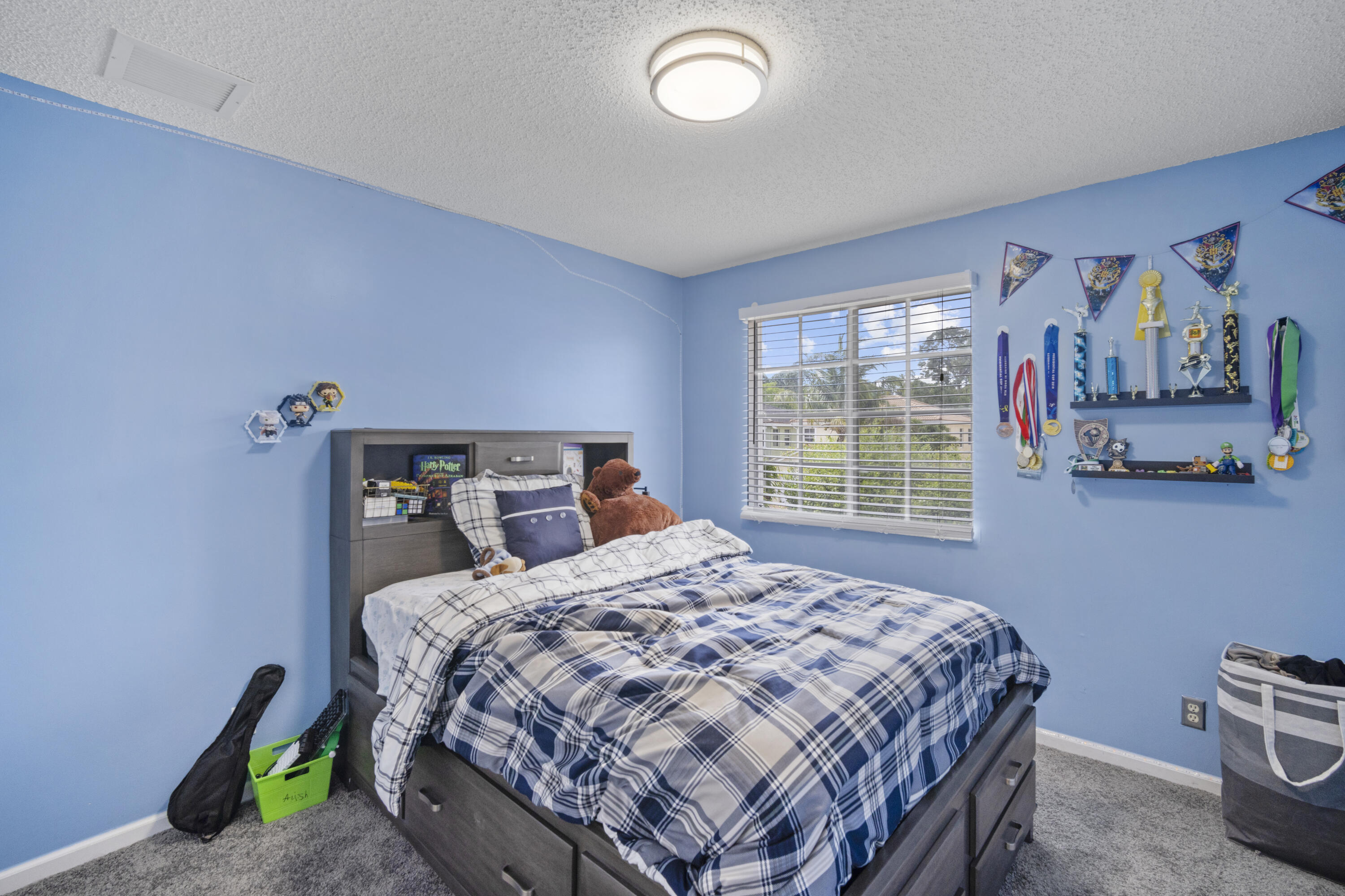 6427 Adriatic Way Greenacres, FL 33413 - Photo 17 of 33 a bedroom with a bed and a window