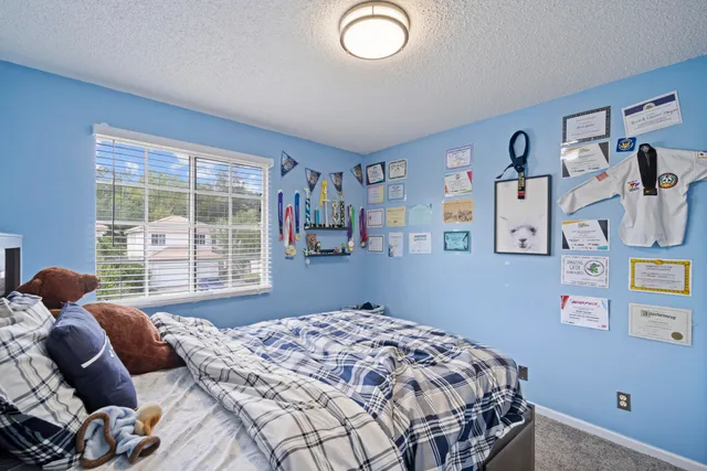 a bedroom with a bed and a window