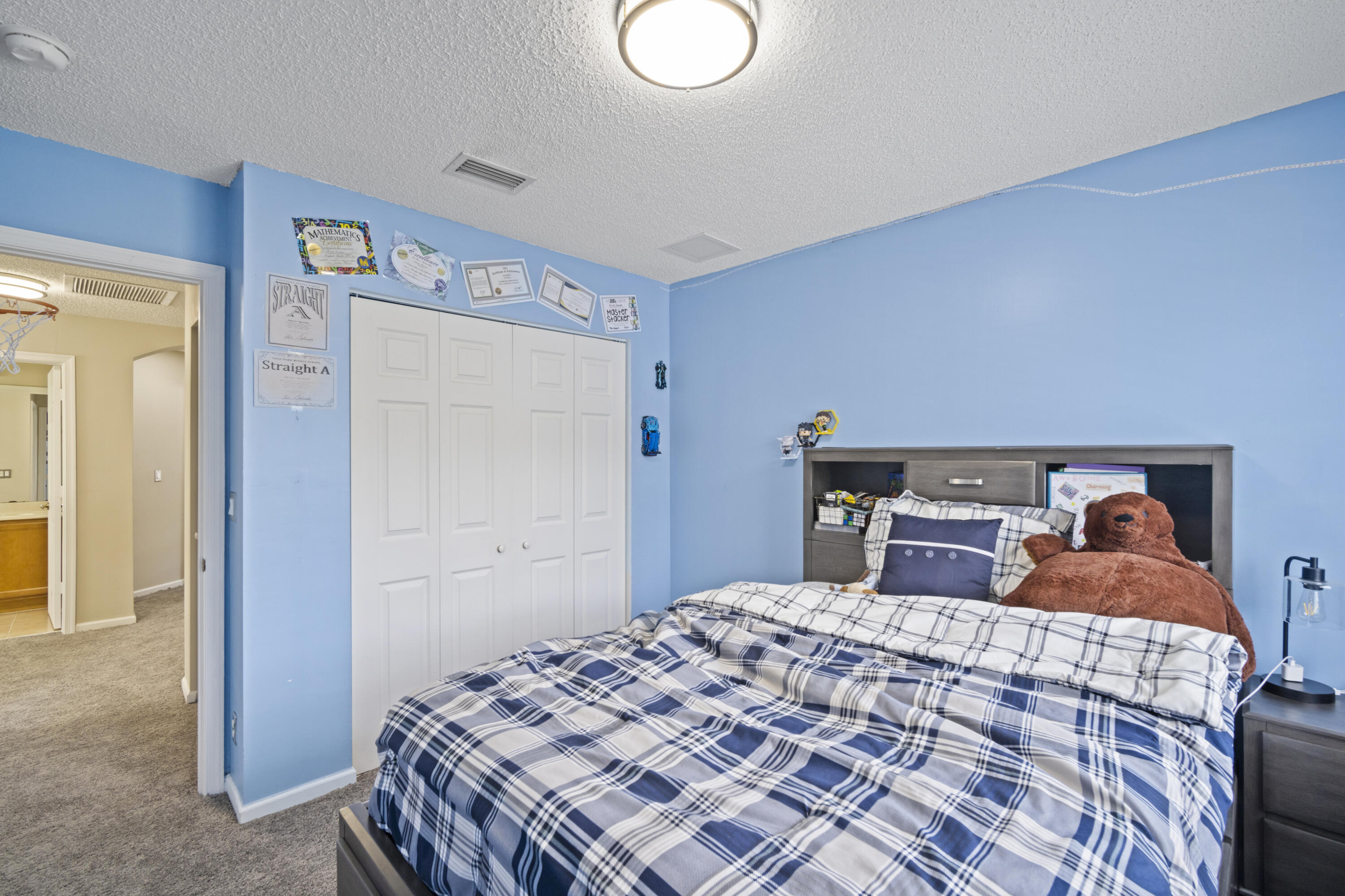 6427 Adriatic Way Greenacres, FL 33413 - Photo 19 of 33 a bedroom with a bed and a cabinets