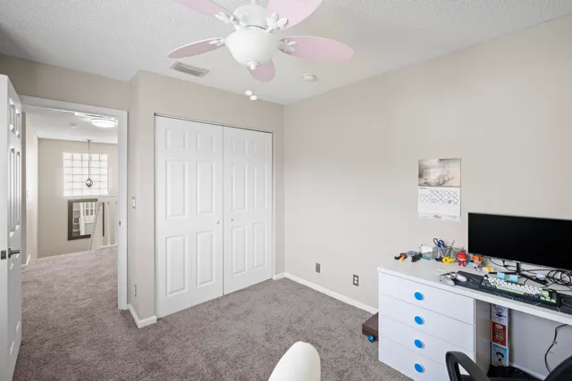 a view of a workspace with furniture and a flat screen tv