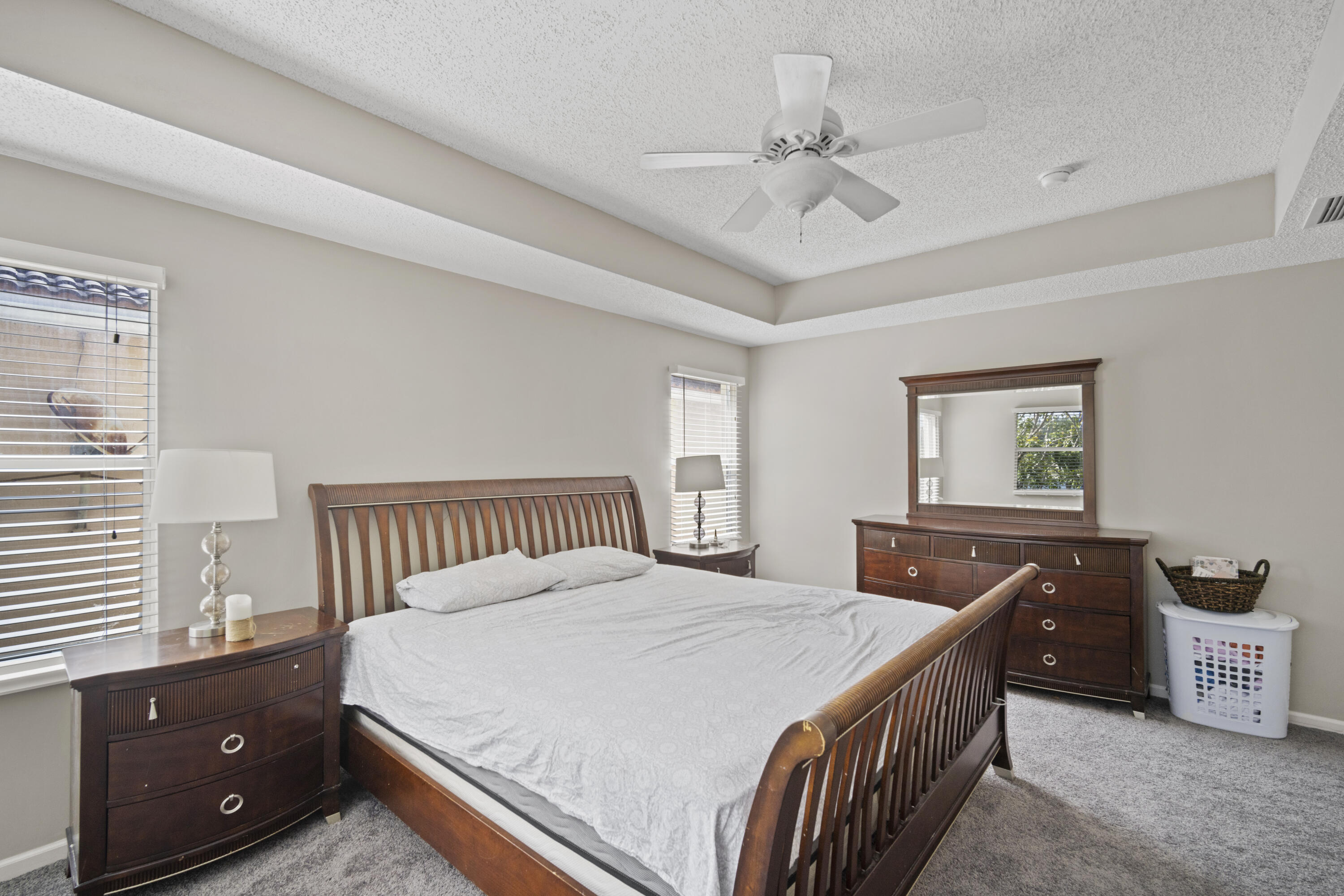 6427 Adriatic Way Greenacres, FL 33413 - Photo 26 of 33 a bedroom with a bed and a dresser