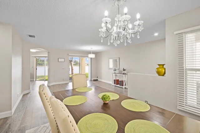 a view of a dining room with furniture and chandelier
