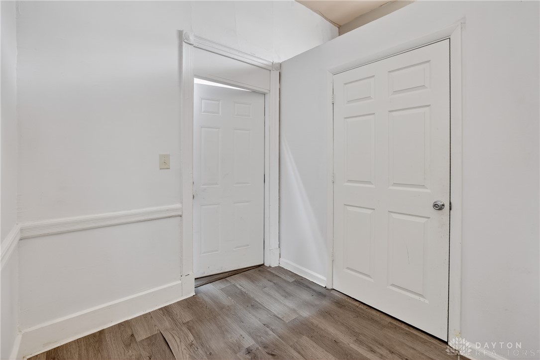 7045-7049 Montgomery Road Cincinnati, OH 45236 - Photo 60 of 68 This interior hallway features classic white paneled doors and durable wood-look flooring.