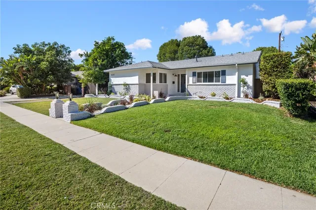 a front view of house with yard and seating area
