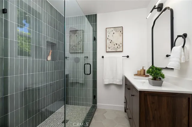 a bathroom with a shower sink and mirror