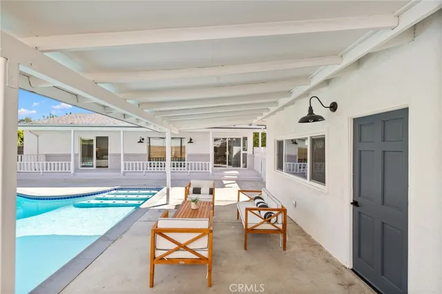 a living room with furniture and a dining table with wooden floor