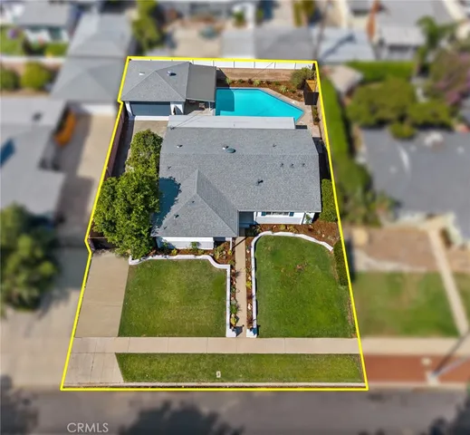 an aerial view of a house with a swimming pool