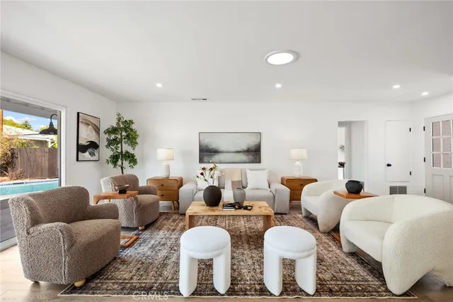 a living room with furniture a lamp and a large window