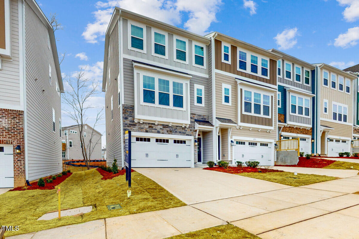 2729 Hunter Wds Drive, Unit 568 Apex, NC 27502 - Photo 1 of 53 a view of a building with many windows