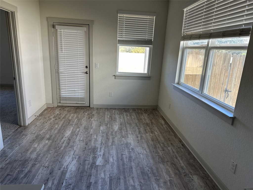 241 Deserti Road Leander, TX 78641 - Photo 8 of 24 an empty room with wooden floor and windows