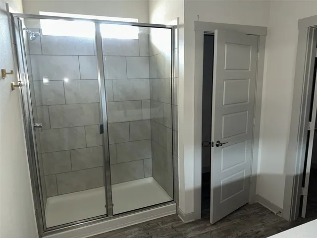 a bathroom with a glass shower door