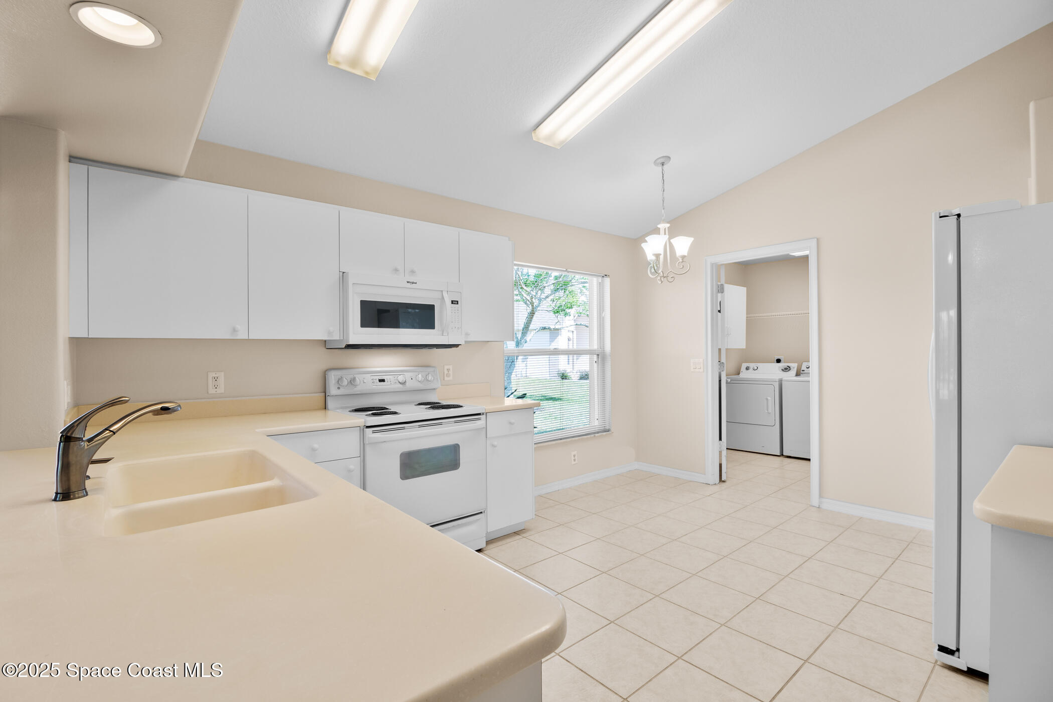 1703 Keys Gate Drive Melbourne, FL 32940 - Photo 22 of 44 a kitchen with a sink a stove and refrigerator