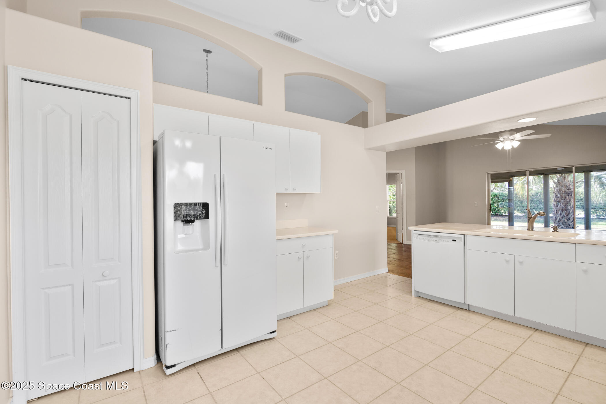 1703 Keys Gate Drive Melbourne, FL 32940 - Photo 24 of 44 a kitchen with white cabinets and white appliances