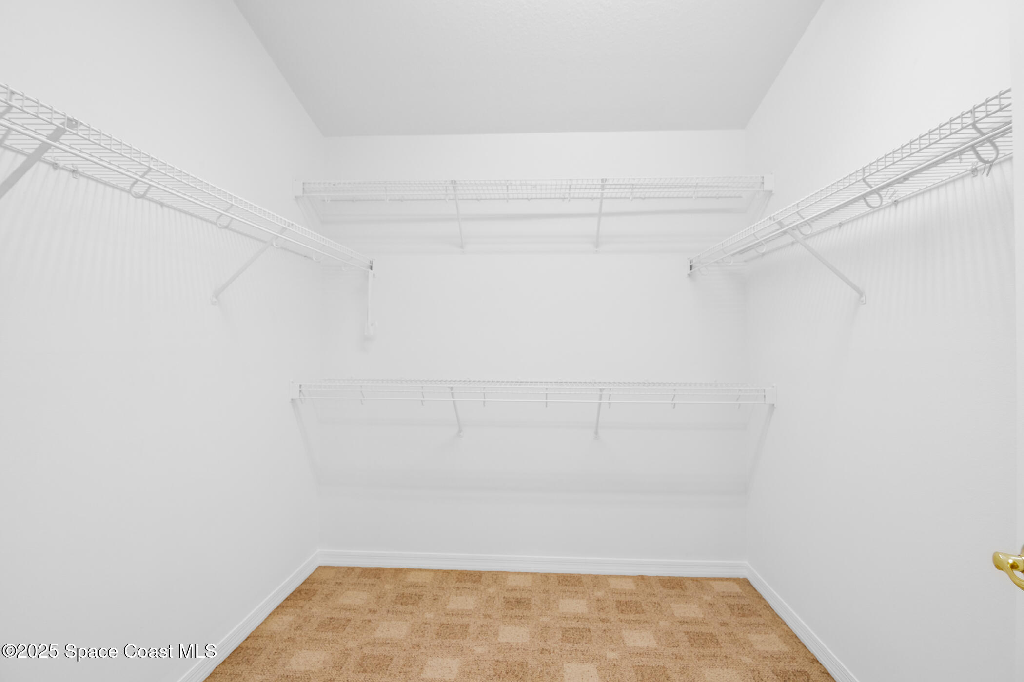 1703 Keys Gate Drive Melbourne, FL 32940 - Photo 27 of 44 a view of a room with racks on the wall