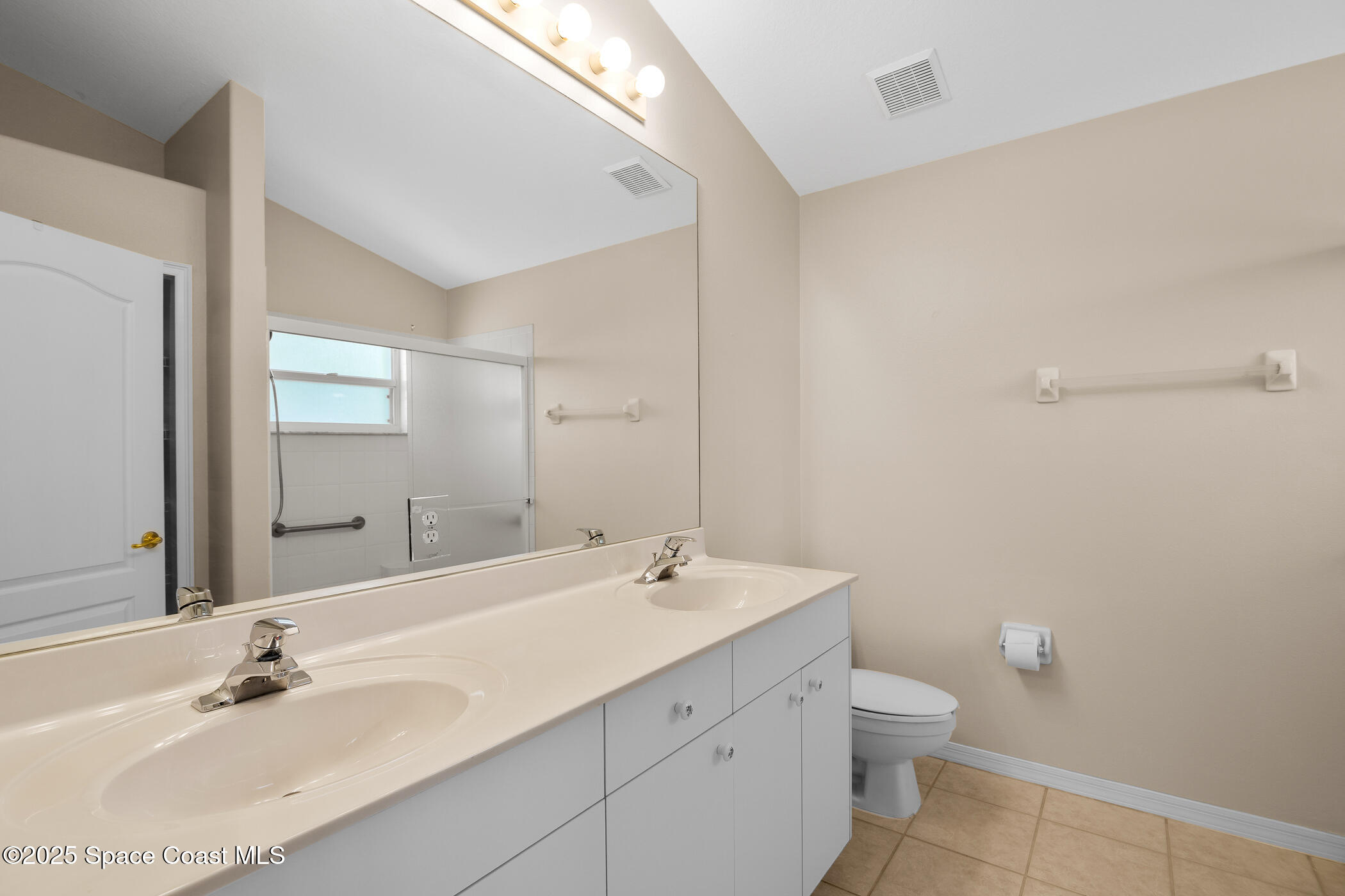 1703 Keys Gate Drive Melbourne, FL 32940 - Photo 28 of 44 a bathroom with a sink a toilet and mirror