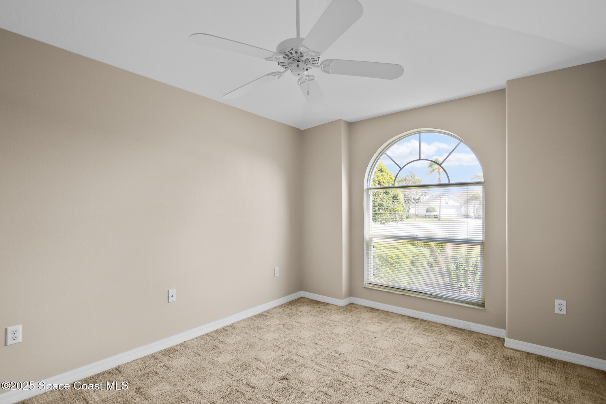 1703 Keys Gate Drive Melbourne, FL 32940 - Photo 31 of 44 an empty room with windows and chandelier fan