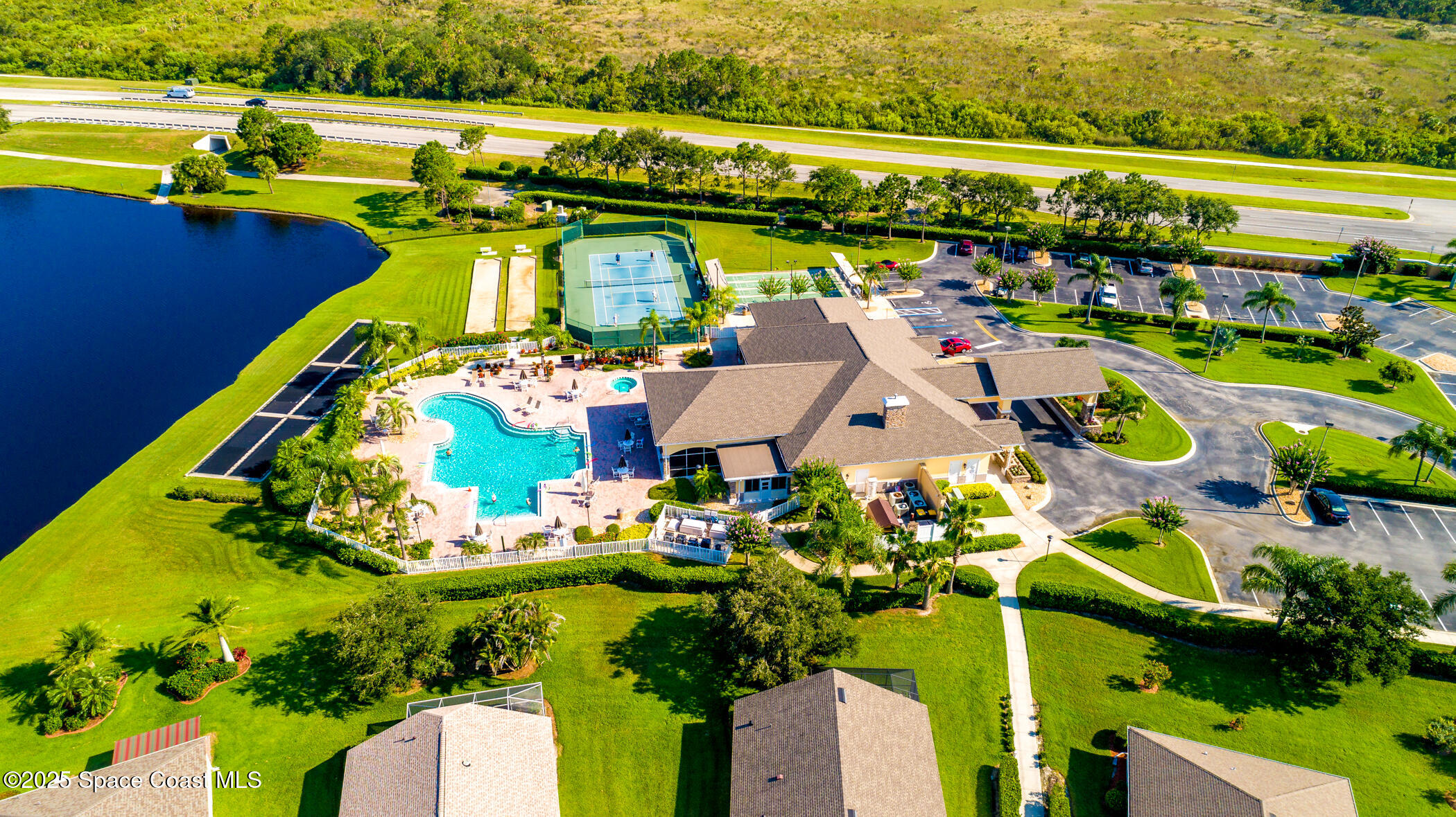 1703 Keys Gate Drive Melbourne, FL 32940 - Photo 37 of 44 an aerial view of a house with a swimming pool outdoor seating and yard