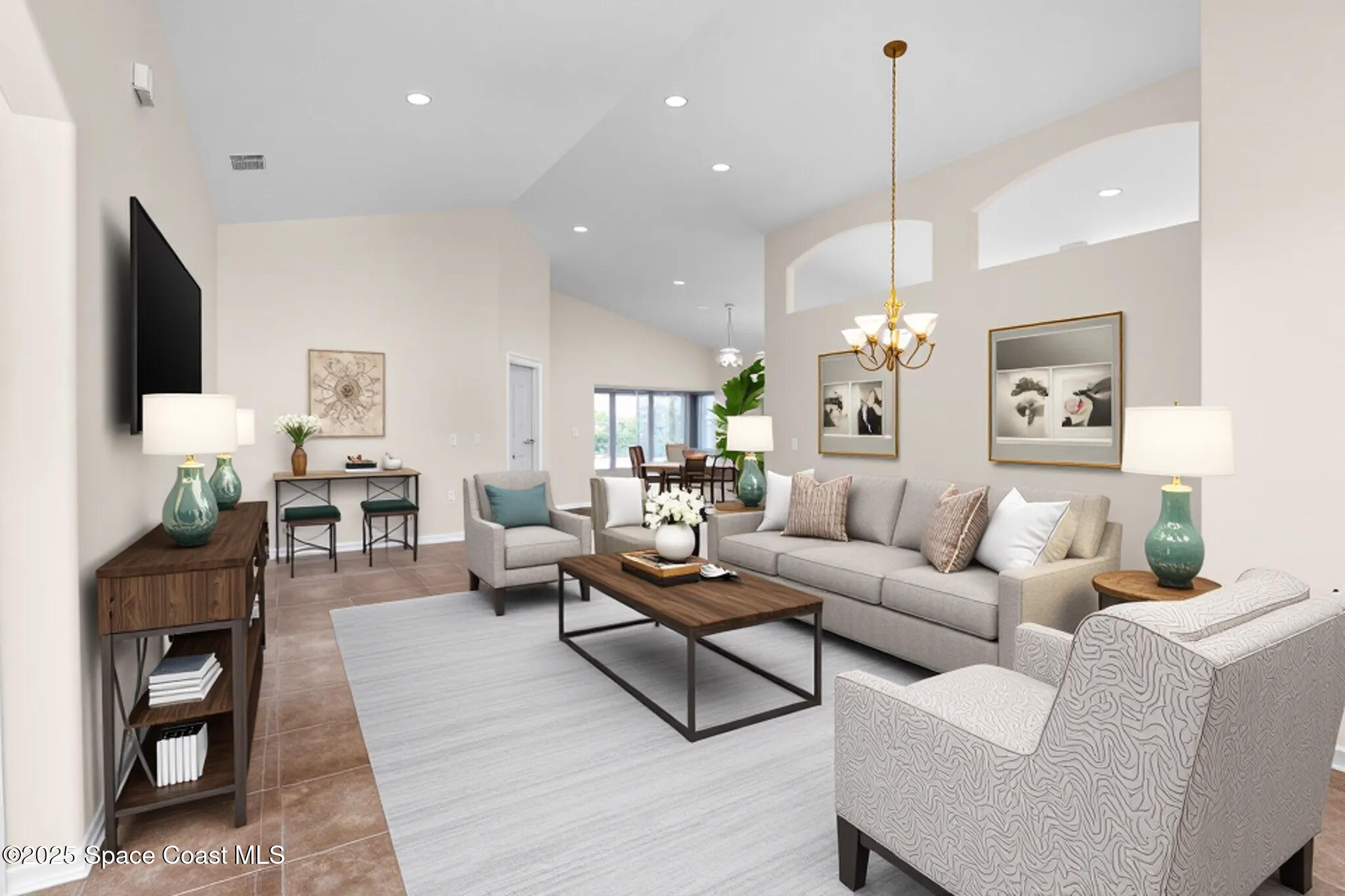 1703 Keys Gate Drive Melbourne, FL 32940 - Photo 5 of 44 a living room with furniture a flat screen tv and a chandelier