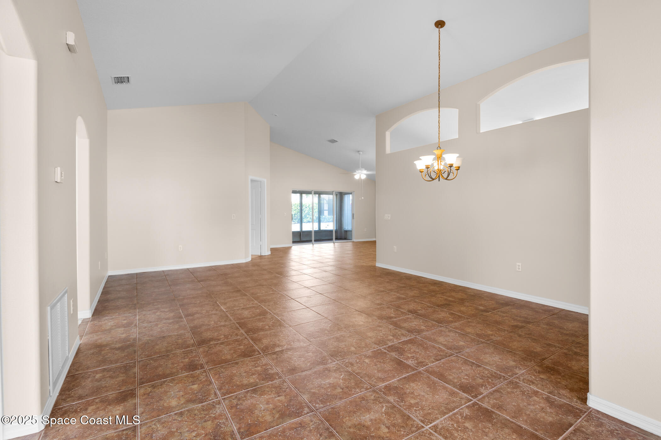 1703 Keys Gate Drive Melbourne, FL 32940 - Photo 6 of 44 a view of a chandelier fan and wooden floor