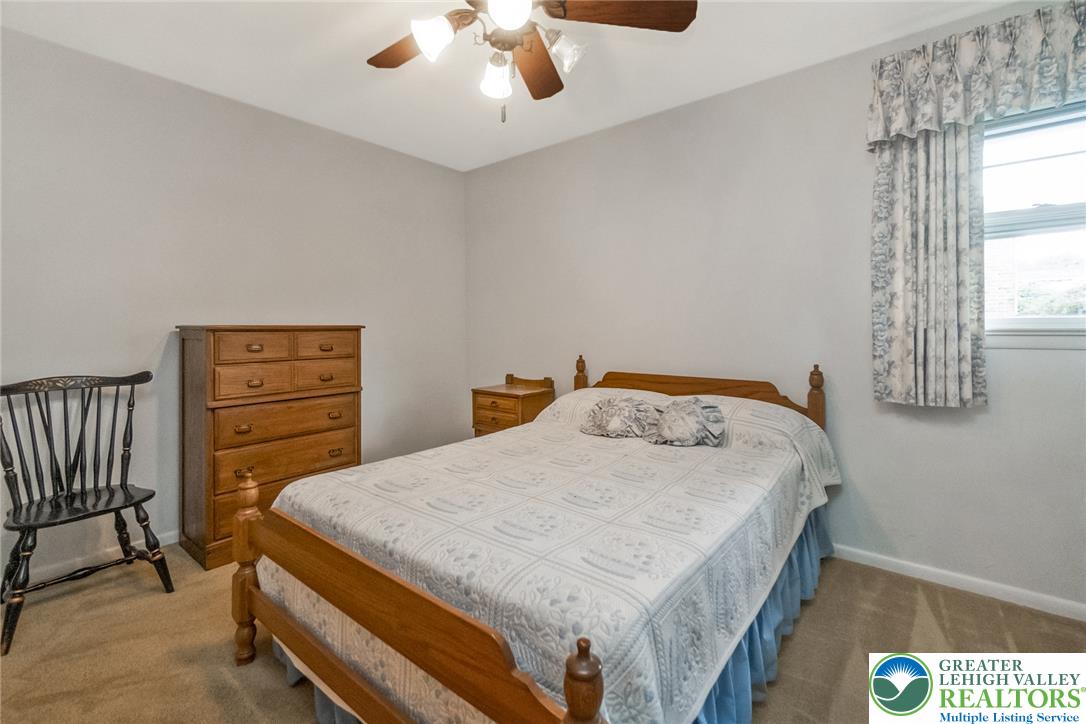 1328 Russett Road Allentown, PA 18104 - Photo 26 of 46 A well-lit bedroom offering a cozy retreat with a large window and convenient overhead lighting.