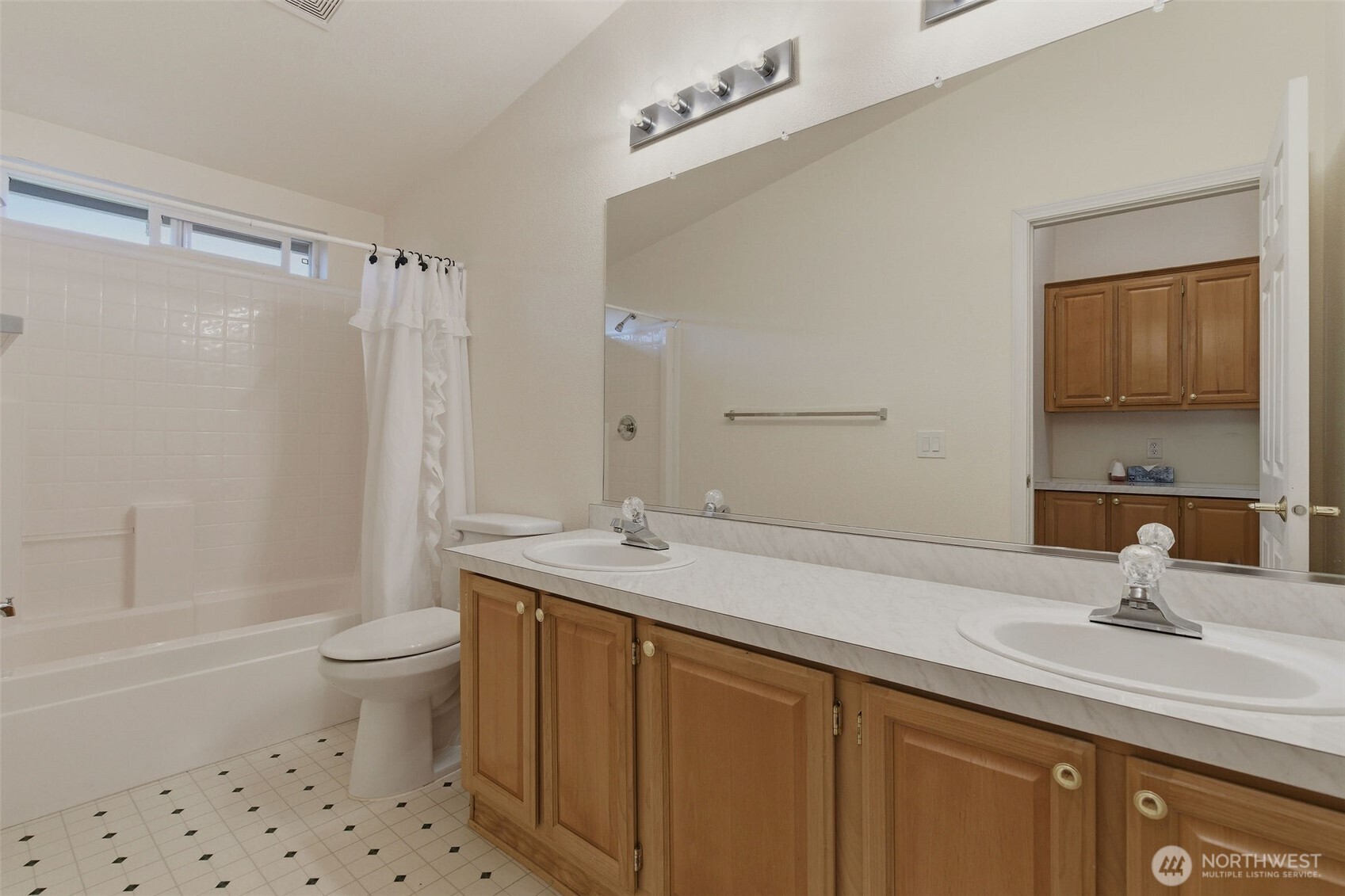 24036 222nd Avenue Southeast Maple Valley, WA 98038 - Photo 20 of 37 a bathroom with a sink toilet a mirror and shower