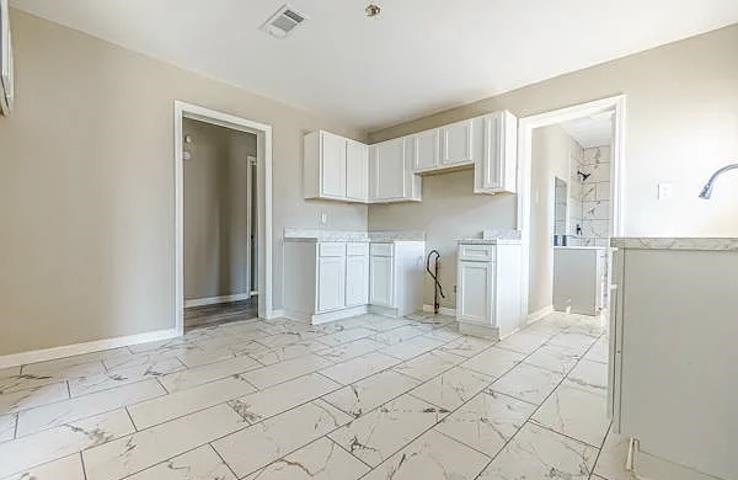 96 Modder Avenue Memphis, TN 38109 - Photo 6 of 12 a view of kitchen with refrigerator cabinets and stove top oven