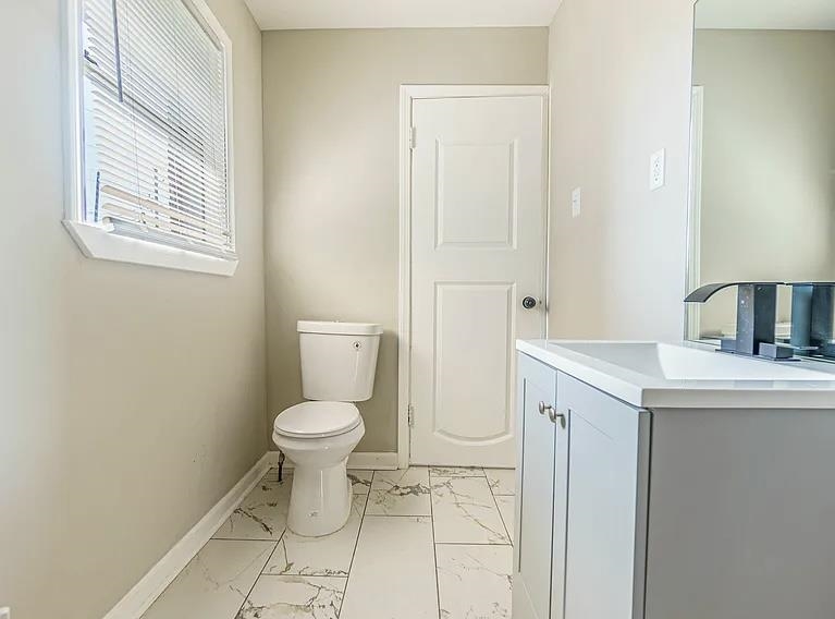 96 Modder Avenue Memphis, TN 38109 - Photo 9 of 12 a bathroom with a toilet sink and vanity