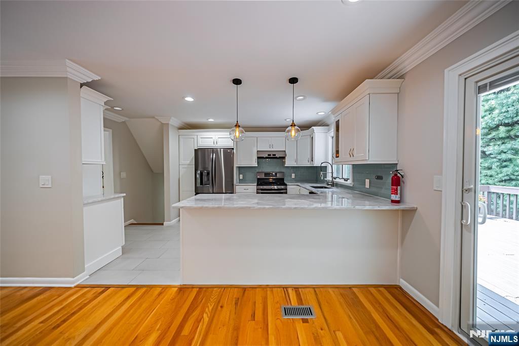 71 Columbus Road Demarest, NJ 07627 - Photo 14 of 50 a living room with stainless steel appliances kitchen island granite countertop a refrigerator and a wooden floor