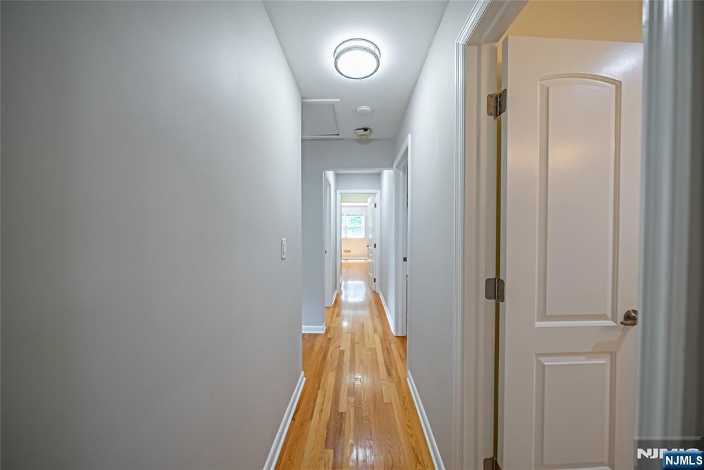 71 Columbus Road Demarest, NJ 07627 - Photo 19 of 50 a view of a hallway with wooden floor and a bathroom
