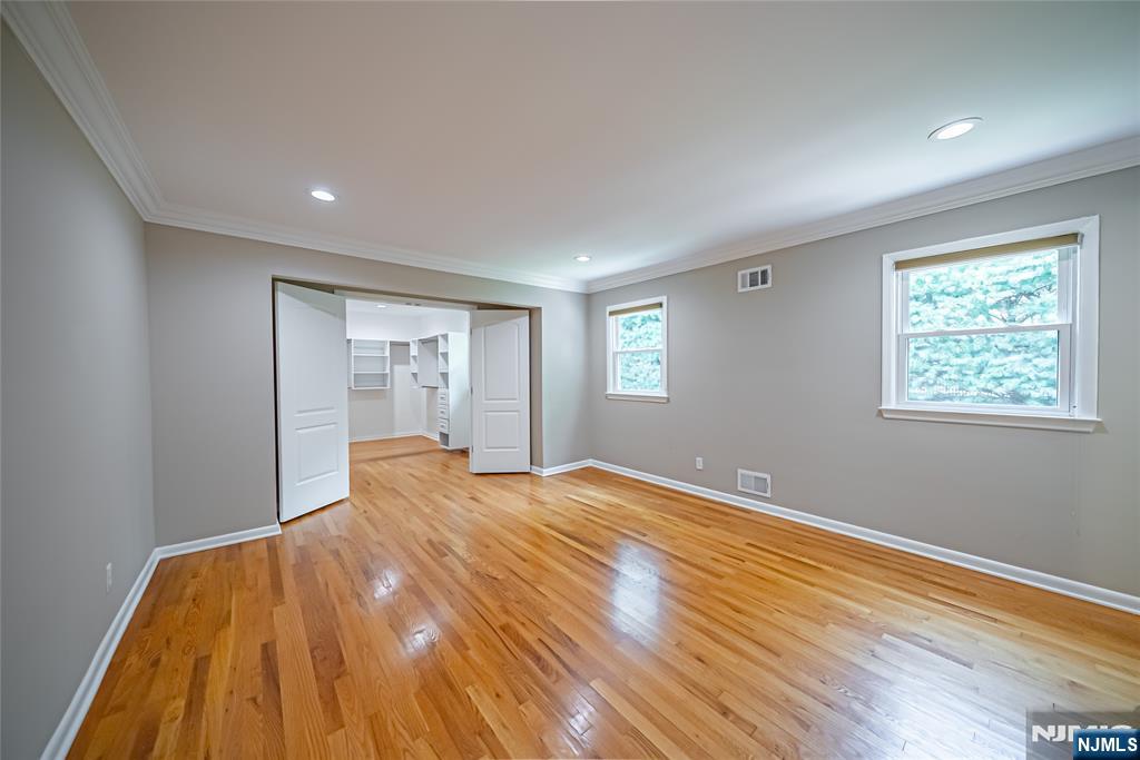 71 Columbus Road Demarest, NJ 07627 - Photo 21 of 50 a view of an empty room with wooden floor and a window