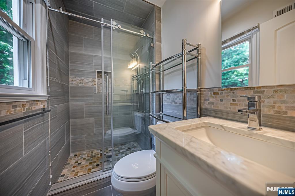 71 Columbus Road Demarest, NJ 07627 - Photo 29 of 50 a bathroom with a sink toilet and shower
