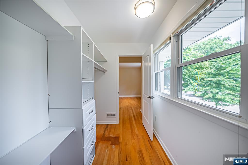 71 Columbus Road Demarest, NJ 07627 - Photo 33 of 50 a hallway with a large window and wooden floor