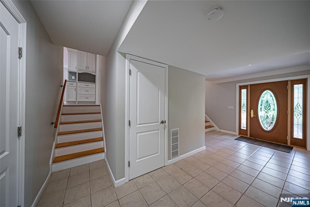 71 Columbus Road Demarest, NJ 07627 - Photo 38 of 50 an empty room with entryway and stairs