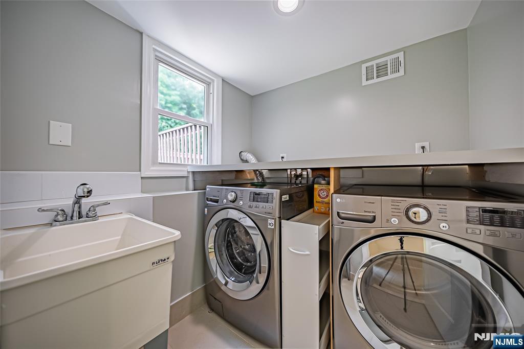 71 Columbus Road Demarest, NJ 07627 - Photo 43 of 50 a utility room with sink dryer and washer