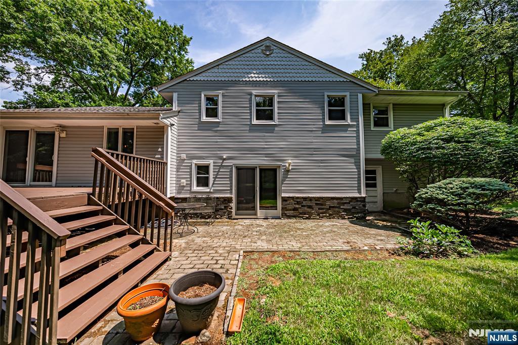 71 Columbus Road Demarest, NJ 07627 - Photo 48 of 50 a front view of house with yard and trees in the background