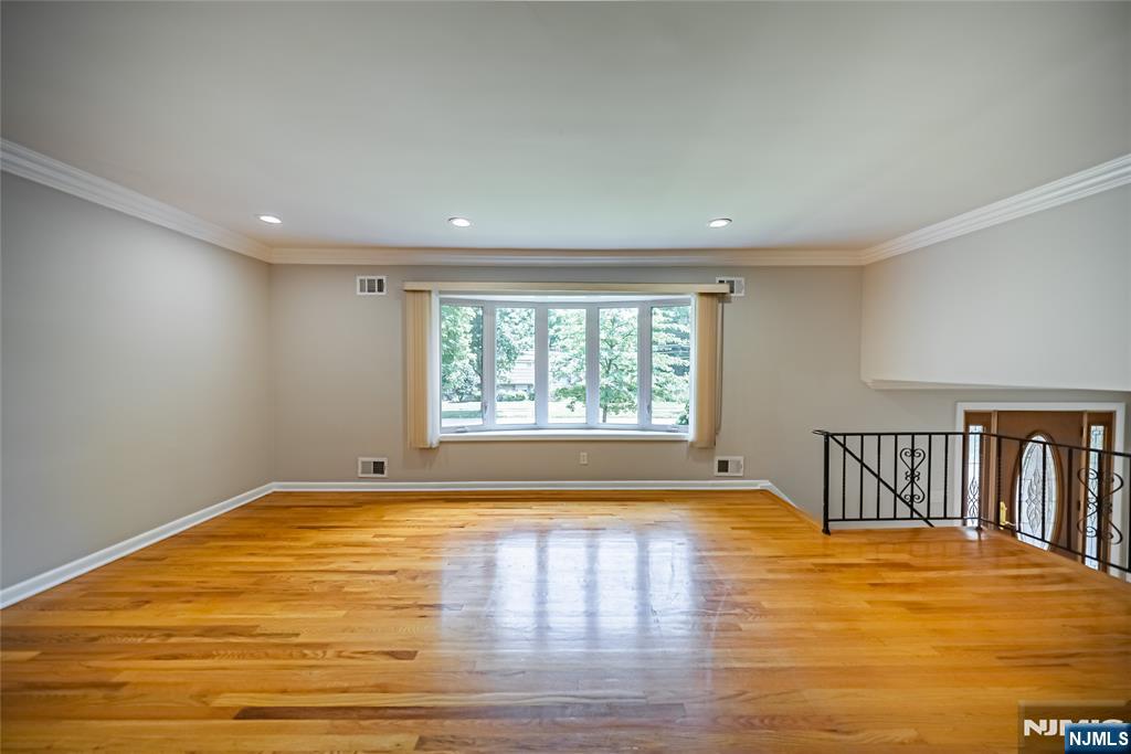 71 Columbus Road Demarest, NJ 07627 - Photo 5 of 50 a view of empty room with wooden floor and fan