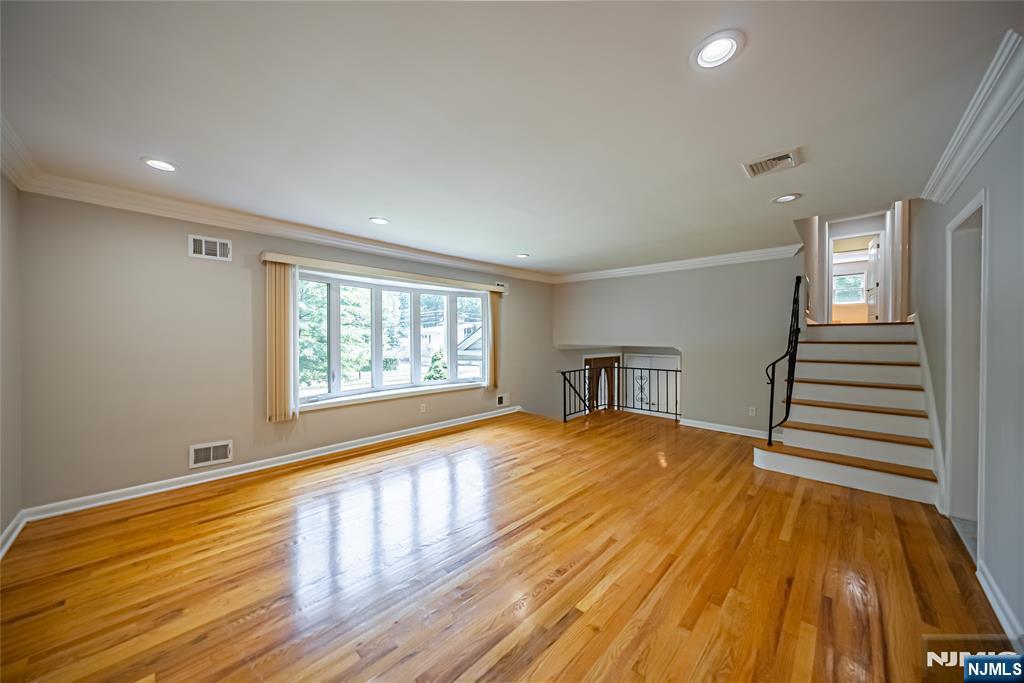 71 Columbus Road Demarest, NJ 07627 - Photo 6 of 50 a view of an empty room with wooden floor and a window