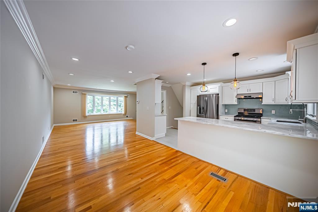 71 Columbus Road Demarest, NJ 07627 - Photo 8 of 50 a large kitchen with kitchen island a sink wooden floor and stainless steel appliances